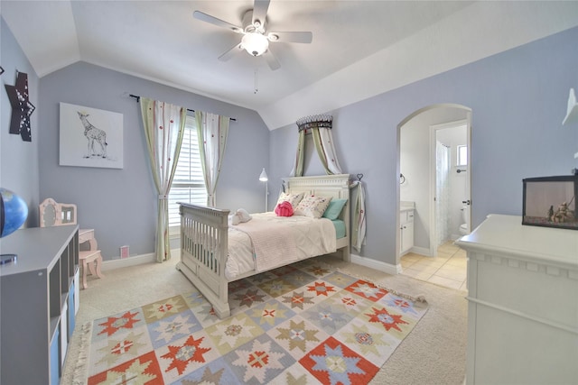 5714 Spring River Ln, Fulshear, TX 77441 - bedroom featuring vaulted ceiling, arched walkways, light colored carpet, a ceiling fan, and connected bathroom