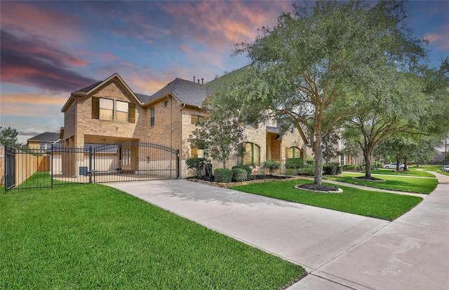5714 Spring River Ln, Fulshear, TX 77441 - view of front facade featuring driveway, a gate, and brick siding
