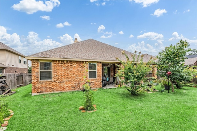 22911 Banff Brook Way, Tomball, TX 77375 - rear view of house with a fenced backyard, brick siding, roof with shingles, a patio area, and a chimney