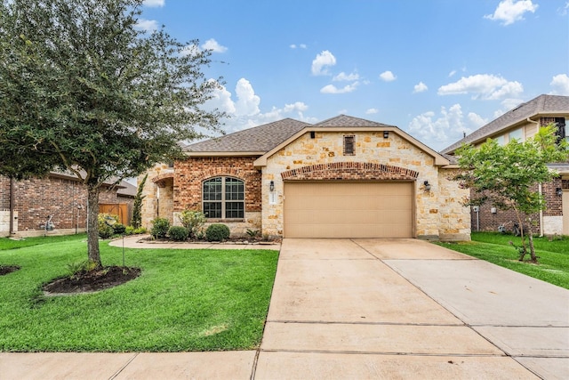 22911 Banff Brook Way, Tomball, TX 77375 - view of front facade featuring an attached garage, a front lawn, driveway, and stone siding