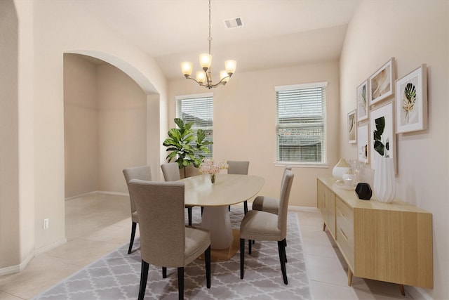 22911 Banff Brook Way, Tomball, TX 77375 - dining room featuring a chandelier, light tile patterned floors, and arched walkways