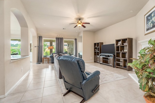 22911 Banff Brook Way, Tomball, TX 77375 - living area with ceiling fan, arched walkways, and light tile patterned flooring
