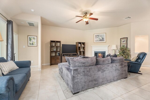 22911 Banff Brook Way, Tomball, TX 77375 - living area with light tile patterned floors, a lit fireplace, and a ceiling fan
