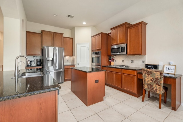 22911 Banff Brook Way, Tomball, TX 77375 - kitchen featuring stainless steel appliances, dark stone countertops, brown cabinets, tasteful backsplash, and recessed lighting