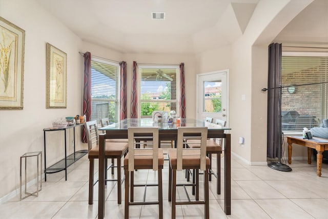 22911 Banff Brook Way, Tomball, TX 77375 - dining space featuring plenty of natural light, light tile patterned floors, and arched walkways