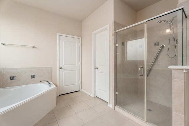 22911 Banff Brook Way, Tomball, TX 77375 - bathroom featuring a stall shower, a bath, and tile patterned floors