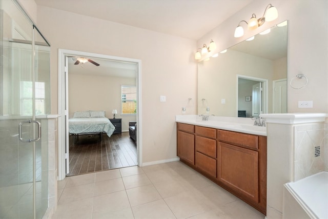 22911 Banff Brook Way, Tomball, TX 77375 - bathroom with double vanity, ceiling fan, connected bathroom, a shower stall, and tile patterned floors