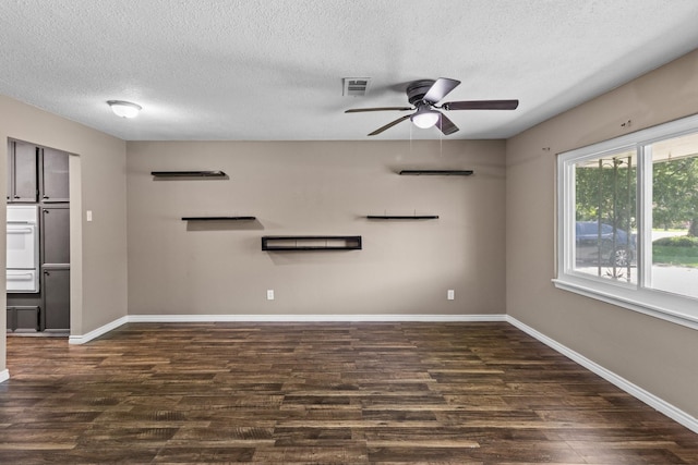 109 Timber Ln, Baytown, TX 77520 - unfurnished living room featuring dark wood finished floors, a ceiling fan, and a textured ceiling
