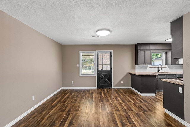 109 Timber Ln, Baytown, TX 77520 - kitchen featuring dark wood-style floors, light countertops, and a textured ceiling
