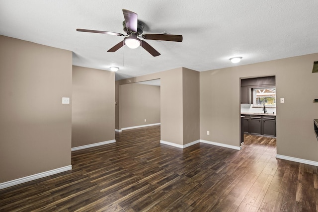 109 Timber Ln, Baytown, TX 77520 - unfurnished living room featuring dark wood-style flooring, a ceiling fan, and a textured ceiling