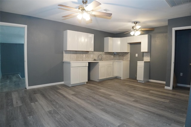 6803 6th St, Hitchcock, TX 77563 - kitchen featuring a ceiling fan, tasteful backsplash, white cabinetry, and dark wood-style flooring