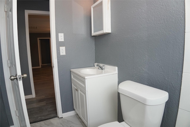 6803 6th St, Hitchcock, TX 77563 - bathroom featuring vanity, a textured wall, and marble finish flooring