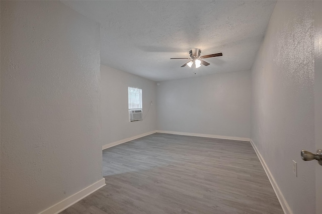 1813 Hatwell St, Houston, TX 77023 - spare room featuring a ceiling fan, wood finished floors, a textured ceiling, and a textured wall