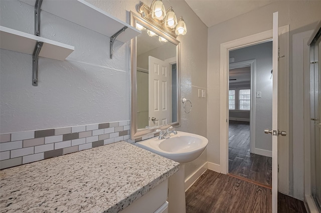 1813 Hatwell St, Houston, TX 77023 - bathroom featuring tasteful backsplash and wood finished floors