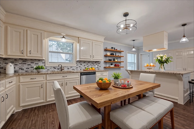 1813 Hatwell St, Houston, TX 77023 - kitchen featuring dishwasher, a chandelier, healthy amount of natural light, tasteful backsplash, and crown molding