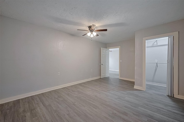 1813 Hatwell St, Houston, TX 77023 - unfurnished bedroom with wood finished floors, a textured ceiling, and ceiling fan