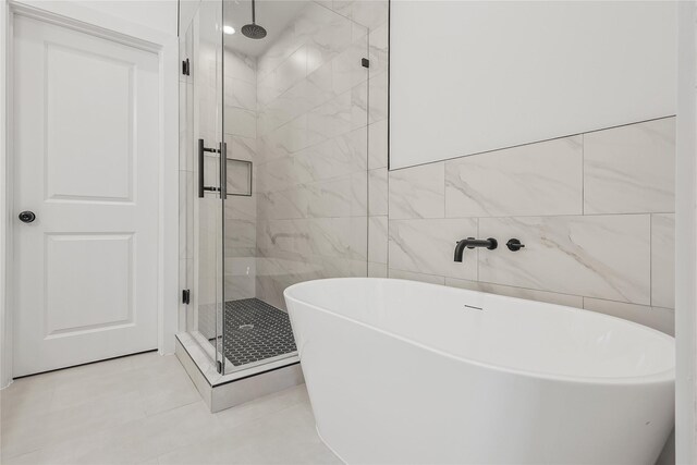 7410 Hezekiah Ln, Houston, TX 77088 - bathroom with a stall shower, a freestanding tub, tile walls, and tile patterned floors