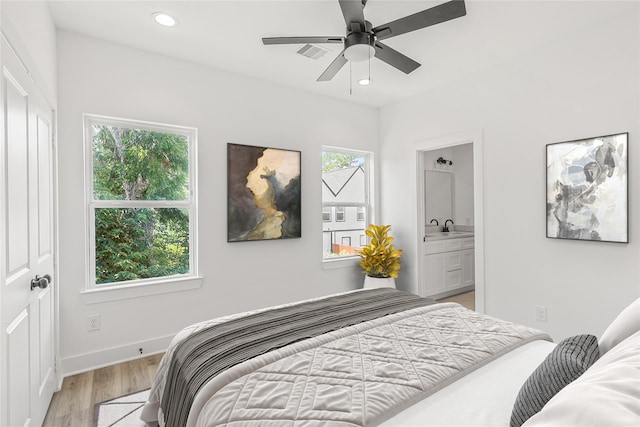 7410 Hezekiah Ln, Houston, TX 77088 - bedroom with light wood-type flooring, recessed lighting, and ensuite bath