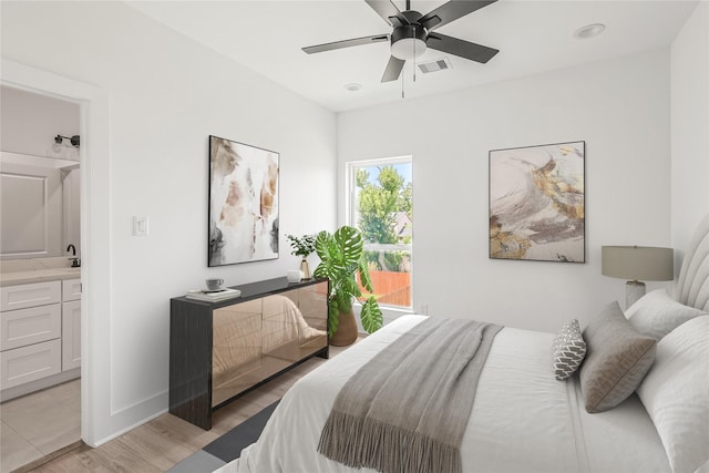 7410 Hezekiah Ln, Houston, TX 77088 - bedroom featuring light wood finished floors, connected bathroom, and a ceiling fan