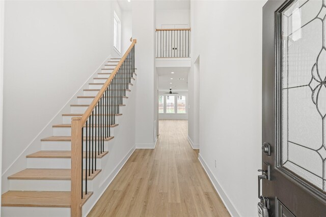 7410 Hezekiah Ln, Houston, TX 77088 - foyer featuring light wood finished floors, stairway, and a towering ceiling