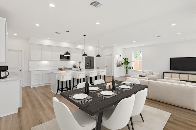7410 Hezekiah Ln, Houston, TX 77088 - dining space with light wood-style flooring and recessed lighting