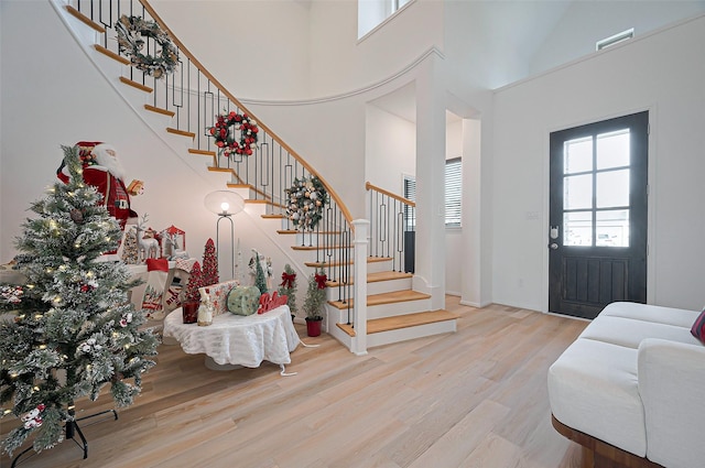 2611 Oakland Park Dr, Conroe, TX 77385 - entryway with wood finished floors, stairway, and a high ceiling