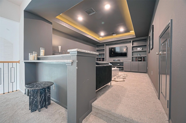 2611 Oakland Park Dr, Conroe, TX 77385 - carpeted cinema room with a tray ceiling and baseboards
