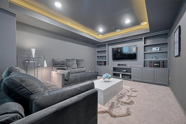 2611 Oakland Park Dr, Conroe, TX 77385 - carpeted cinema with a tray ceiling, recessed lighting, and built in shelves