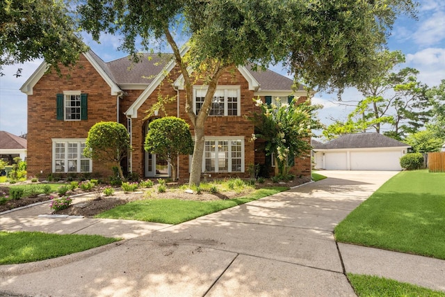 2125 Tipperary Dr, Pearland, TX 77581 - traditional-style house with brick siding, a front lawn, a detached garage, and concrete driveway