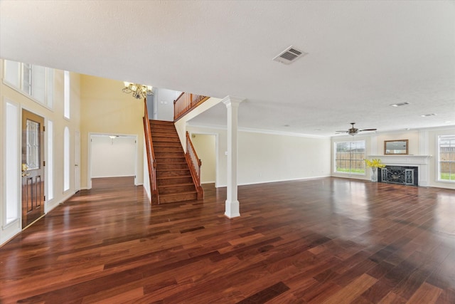2125 Tipperary Dr, Pearland, TX 77581 - unfurnished living room featuring wood finished floors, ceiling fan, a fireplace, stairway, and crown molding