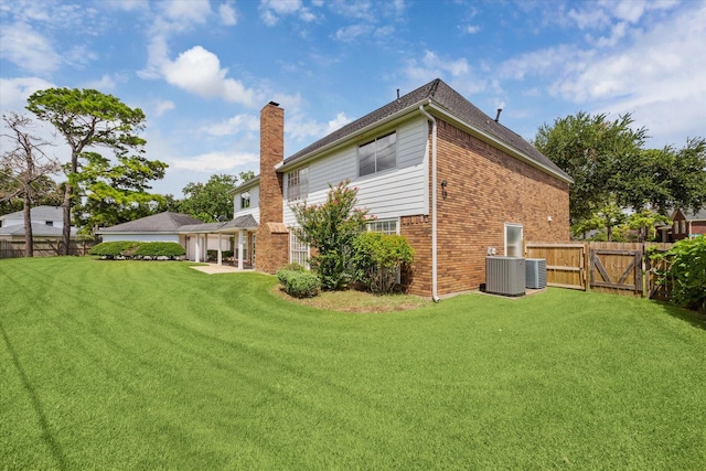 2125 Tipperary Dr, Pearland, TX 77581 - rear view of house featuring a chimney, brick siding, a garage, and a gate