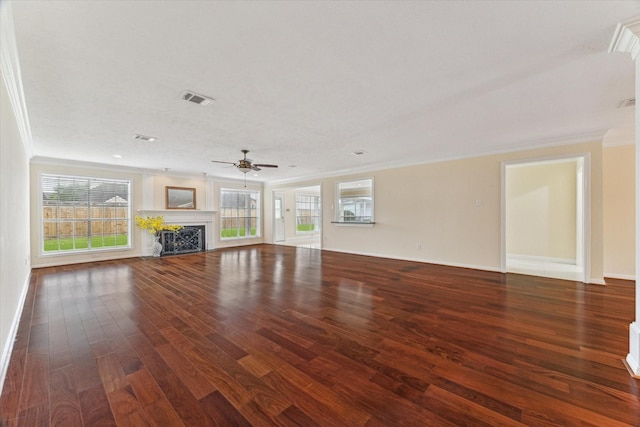 2125 Tipperary Dr, Pearland, TX 77581 - unfurnished living room featuring crown molding, wood finished floors, ceiling fan, healthy amount of natural light, and a premium fireplace