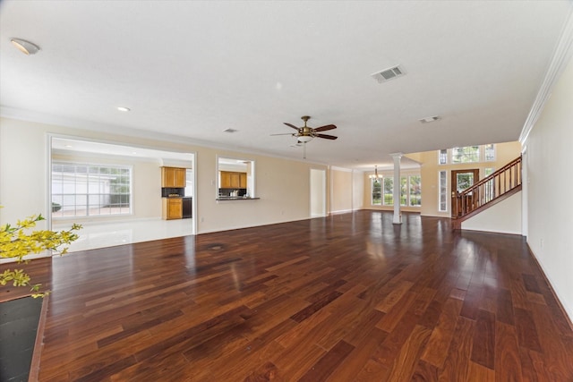 2125 Tipperary Dr, Pearland, TX 77581 - unfurnished living room featuring ornate columns, ornamental molding, ceiling fan, wood finished floors, and healthy amount of natural light