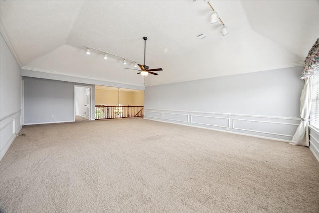 2125 Tipperary Dr, Pearland, TX 77581 - carpeted spare room with rail lighting, vaulted ceiling, a ceiling fan, a decorative wall, and wainscoting