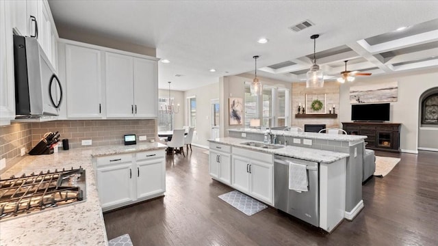 14926 Kenton Place Ln, Cypress, TX 77429 - kitchen featuring stainless steel appliances, a fireplace, open floor plan, backsplash, and a ceiling fan