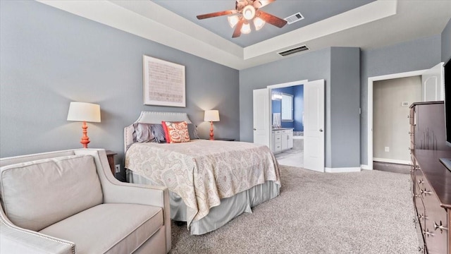 14926 Kenton Place Ln, Cypress, TX 77429 - carpeted bedroom featuring a tray ceiling, ensuite bath, and ceiling fan