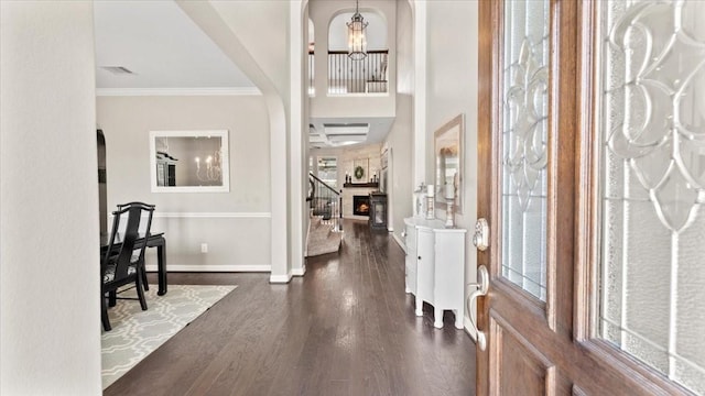 14926 Kenton Place Ln, Cypress, TX 77429 - entrance foyer featuring dark wood-style flooring, a chandelier, crown molding, and arched walkways