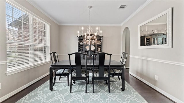 14926 Kenton Place Ln, Cypress, TX 77429 - dining space with a chandelier, arched walkways, dark wood-style floors, and crown molding