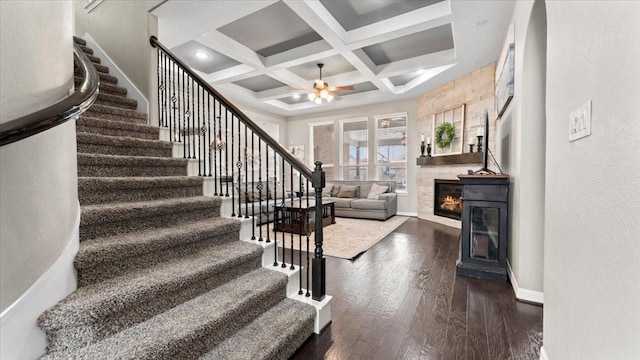 14926 Kenton Place Ln, Cypress, TX 77429 - stairway featuring ceiling fan, coffered ceiling, wood finished floors, a large fireplace, and beamed ceiling