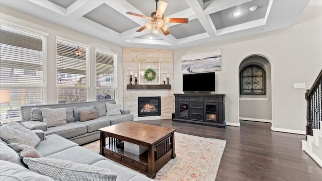 14926 Kenton Place Ln, Cypress, TX 77429 - living area featuring coffered ceiling, a large fireplace, a ceiling fan, beam ceiling, and stairs