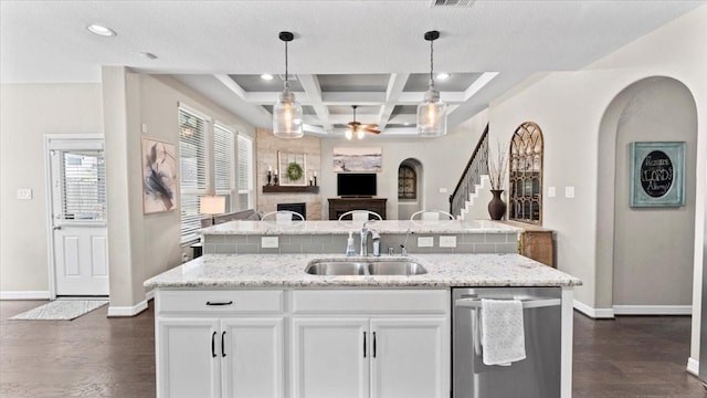 14926 Kenton Place Ln, Cypress, TX 77429 - kitchen featuring open floor plan, a ceiling fan, a fireplace, dark wood-style flooring, and a kitchen island with sink
