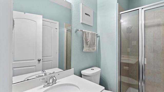 14926 Kenton Place Ln, Cypress, TX 77429 - full bathroom featuring vanity, a stall shower, and a textured wall