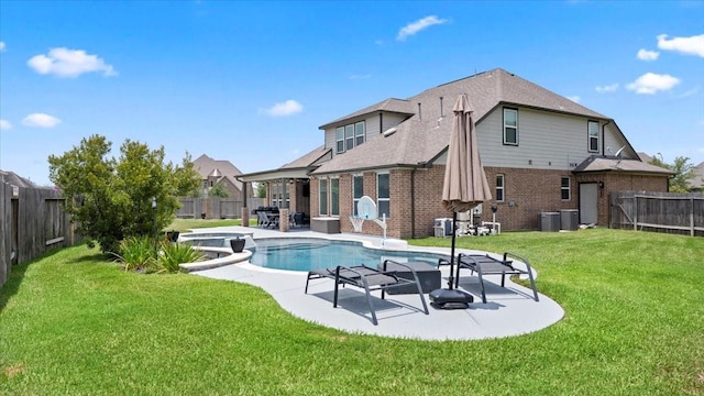 14926 Kenton Place Ln, Cypress, TX 77429 - back of house with brick siding, a fenced backyard, a patio, and an in-ground hot tub