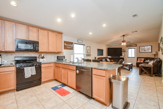 24631 Lakecrest Town Dr, Katy, TX 77493 - kitchen featuring black appliances, a peninsula, vaulted ceiling, light brown cabinets, and open floor plan