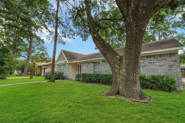 25515 Pepper Ridge Ln, Spring, TX 77373 - ranch-style house with an attached garage, a front lawn, brick siding, and a shingled roof