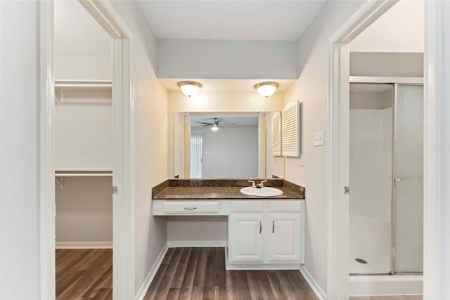 25515 Pepper Ridge Ln, Spring, TX 77373 - full bath featuring a stall shower, wood finished floors, vanity, a walk in closet, and a ceiling fan