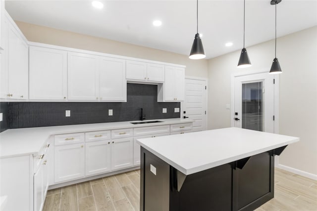 4120 S Kemp Ave, Edinburg, TX 78542 - kitchen featuring backsplash, wood finish floors, white cabinets, and recessed lighting