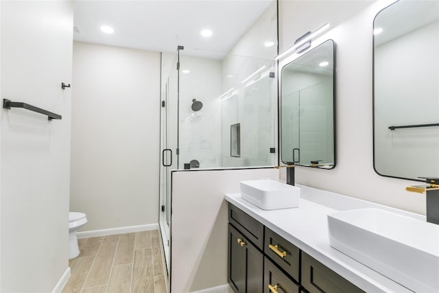 4120 S Kemp Ave, Edinburg, TX 78542 - full bathroom with double vanity, a shower stall, recessed lighting, and wood tiled floors