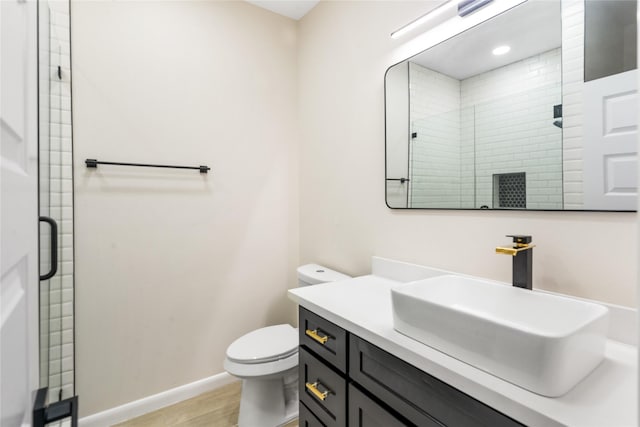 4120 S Kemp Ave, Edinburg, TX 78542 - bathroom featuring wood finished floors, vanity, and a stall shower