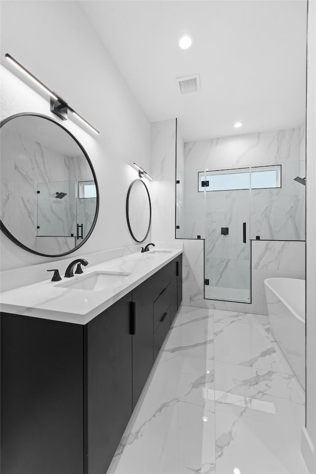 5203 San Juan St, Houston, TX 77020 - bathroom with a marble finish shower, double vanity, a freestanding bath, and marble finish flooring
